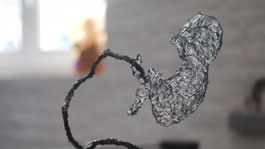 Death Stranding Baby sculpted with a 3d pen and clear plastic strands.