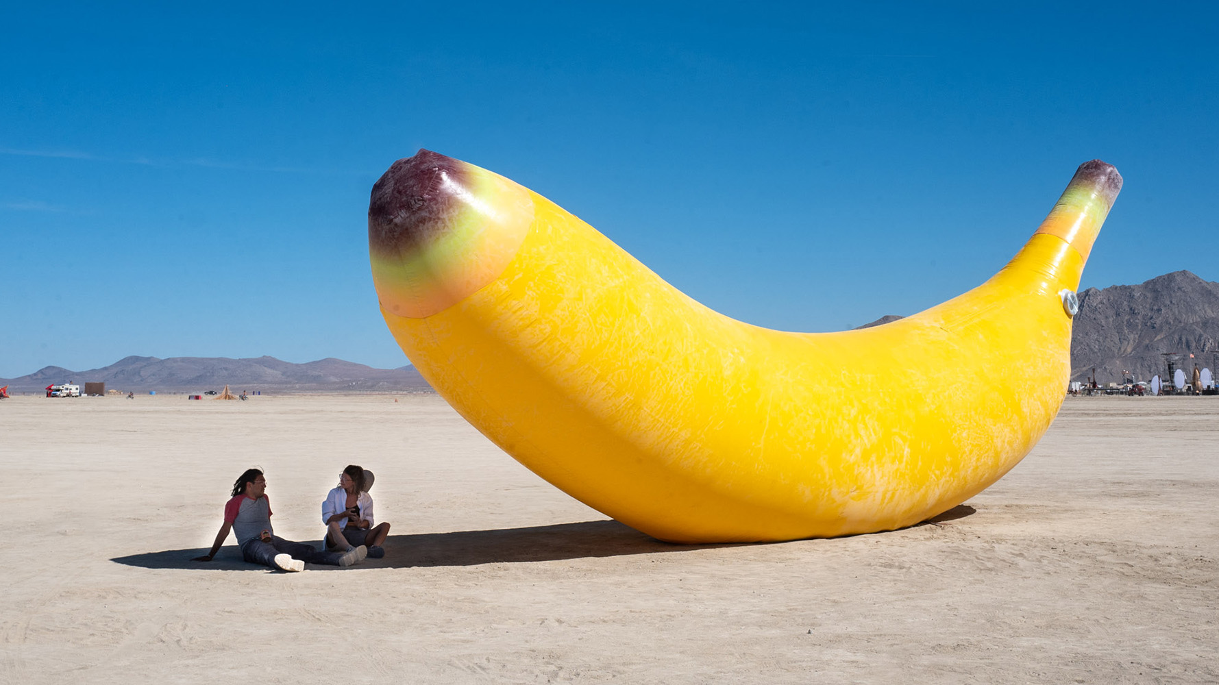 Riikc under the shade of the giant banana at burning man