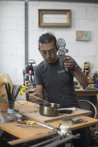 Adding hot wax to the BT baby sculpture