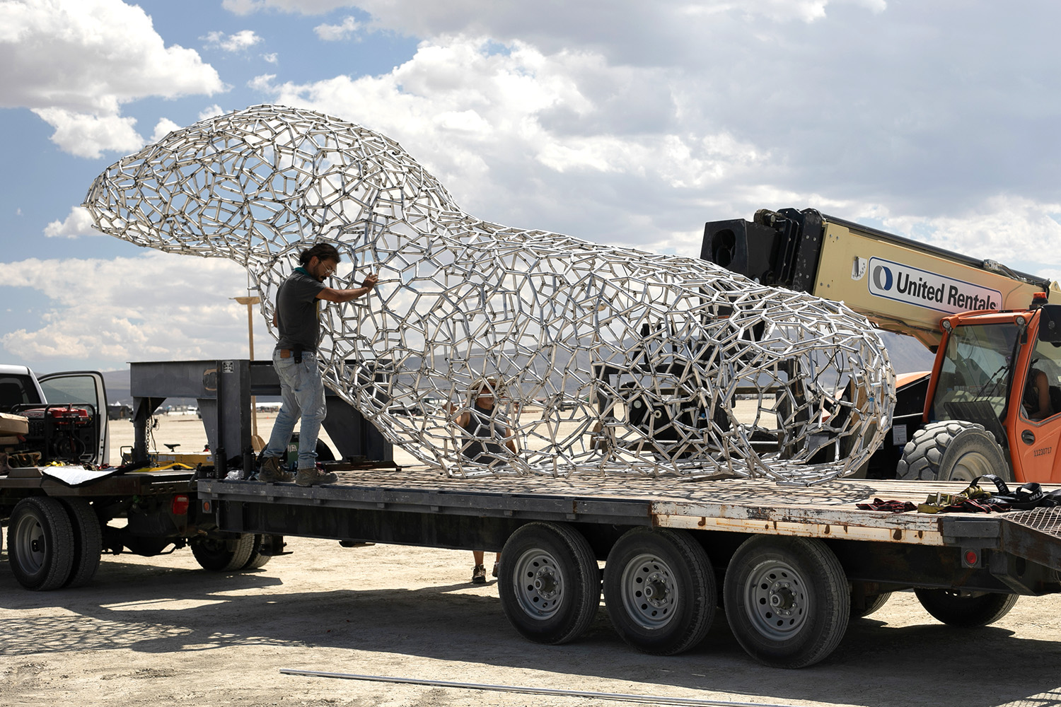 Unloading the axolotl sculpture at Black Rock City